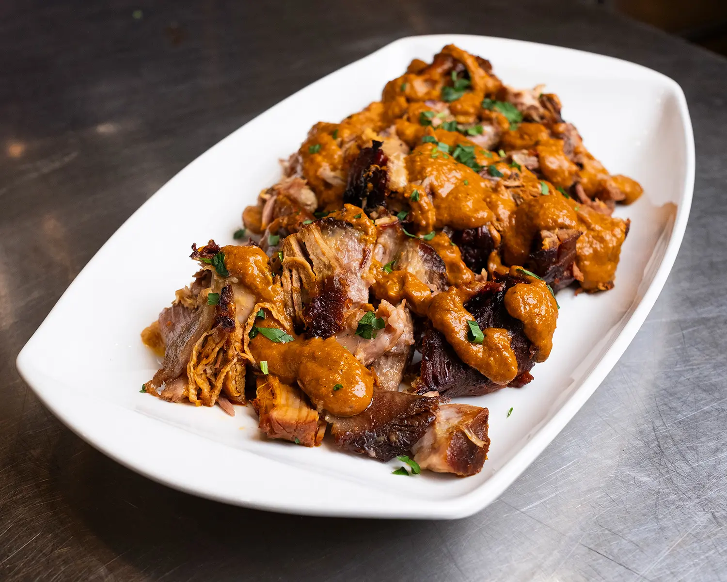 Succulent pork roast, marinated overnight in a spicy harissa, garlic, and pomegranate molasses mixture.