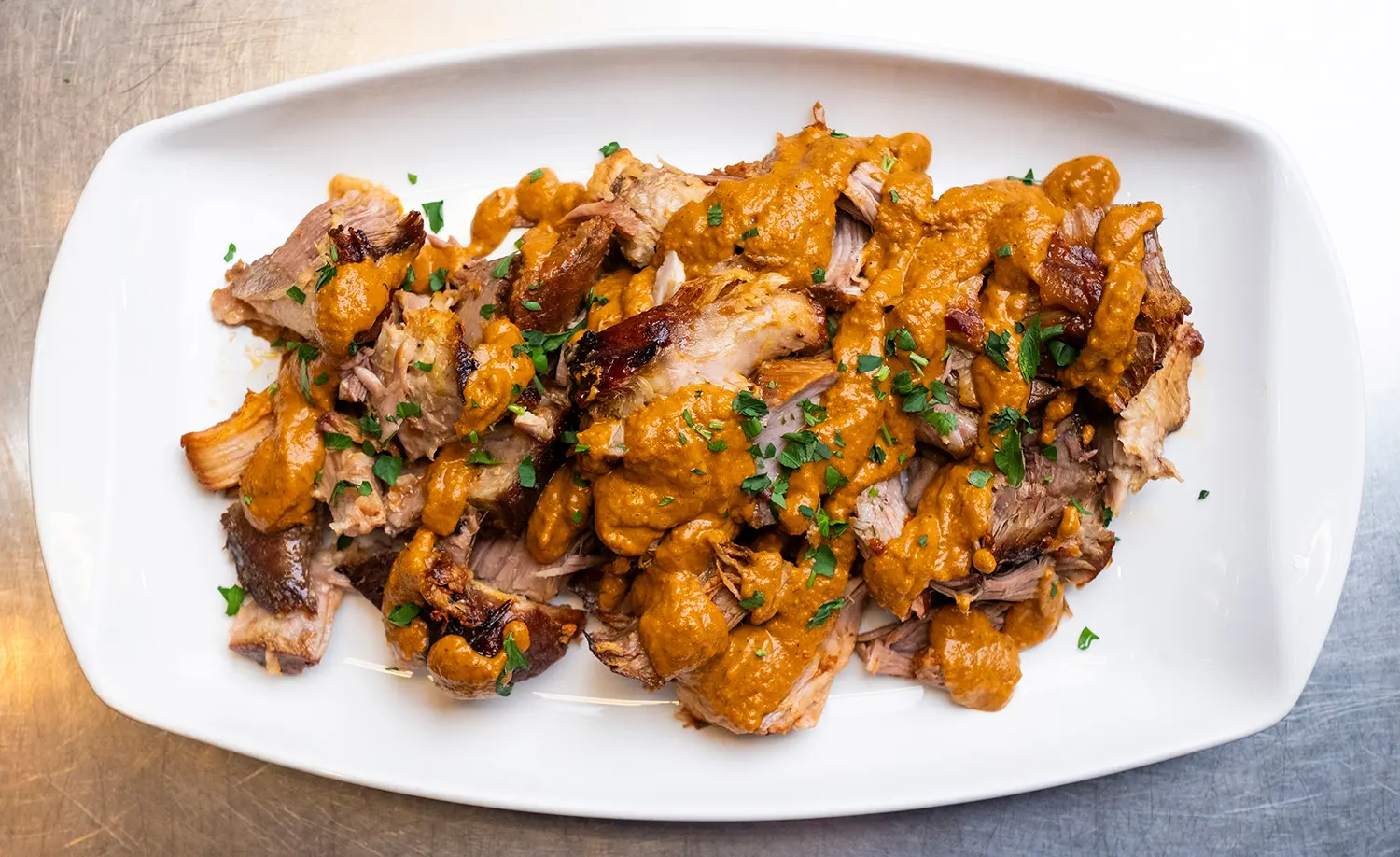 Succulent pork roast, marinated overnight in a spicy harissa, garlic, and pomegranate molasses mixture.