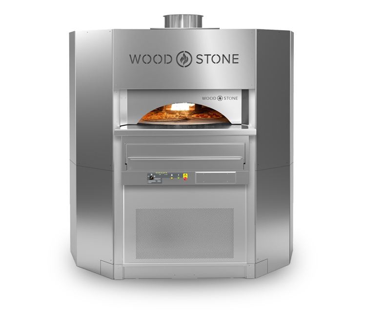A large, stainless steel Wood Stone OneRev commercial oven featuring a faceted body, an arched front opening revealing pizzas baking on a rotating stone hearth, and an integrated digital control panel below.
